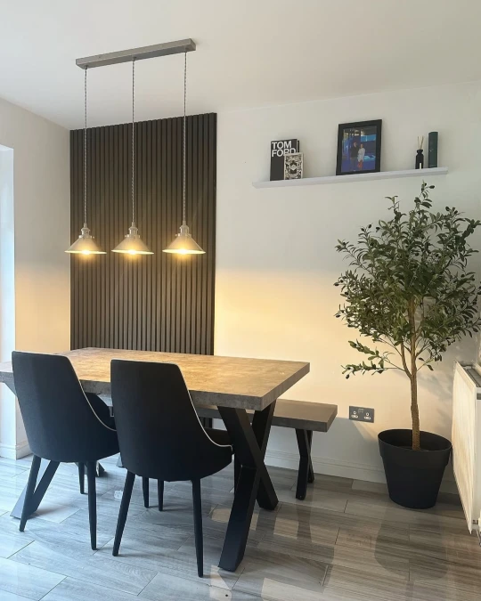 Charcoal Slat Accent Panel Behind a Dining Table