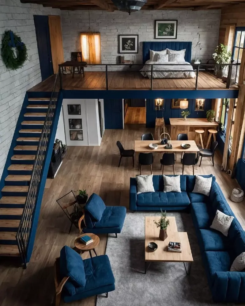 Cobalt blue sectional with matching painted staircase and whitewashed brick loft bedroom