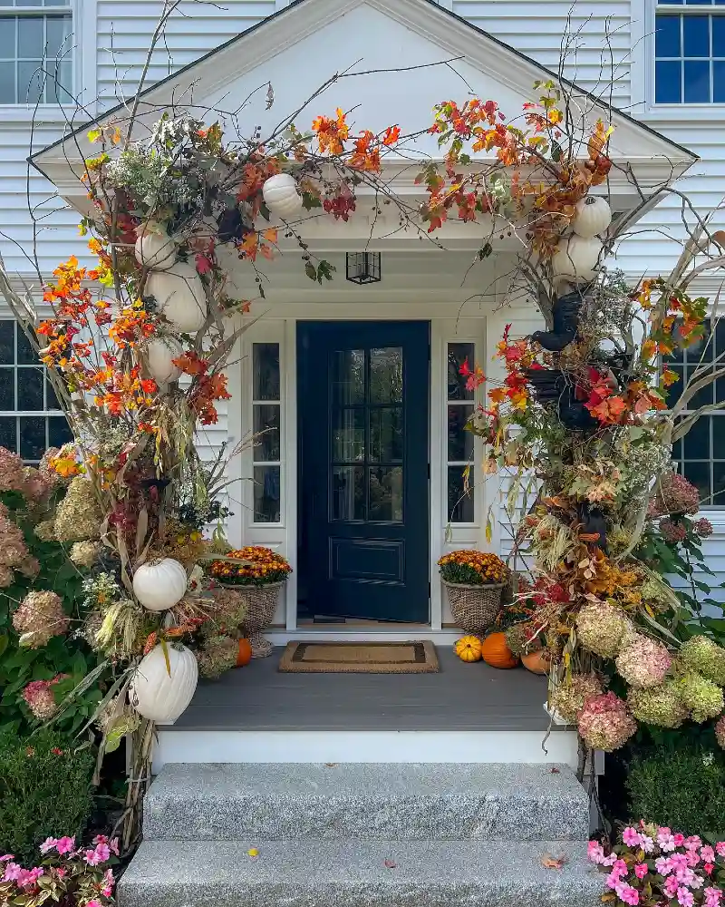 Colonial Entry Portico with Ornate Branch Archway, Hanging White Pumpkins, and Basket Planters