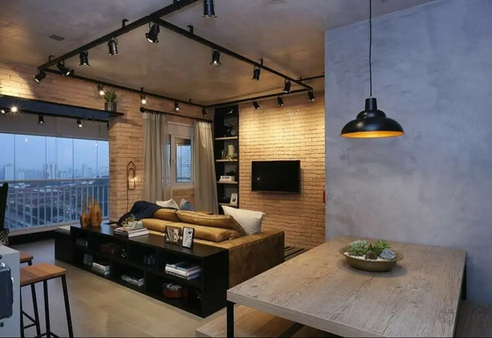 Compact Apartment Living Room With Track Lighting And Brick Accent