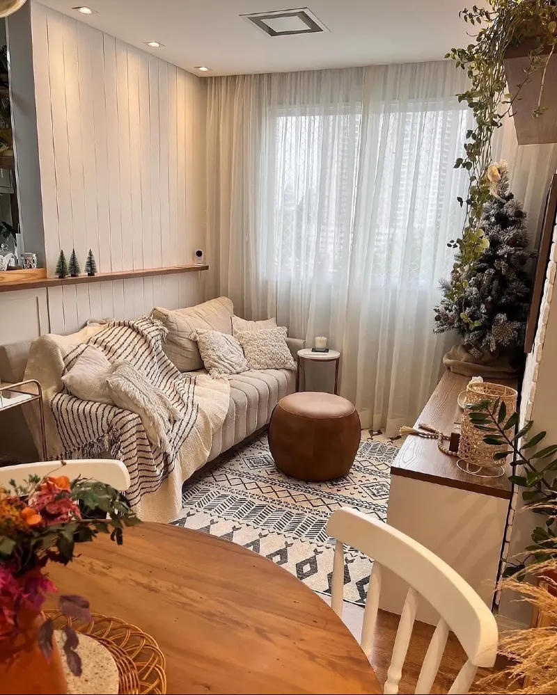 Compact Sofa Layout with Round Leather Ottoman and Window End Focus