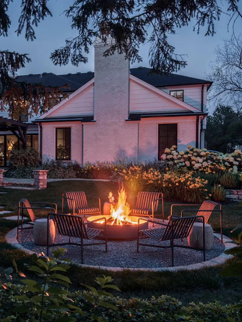 Contemporary Gravel Fire Lounge with Sculptural Metal Chairs and Garden Border