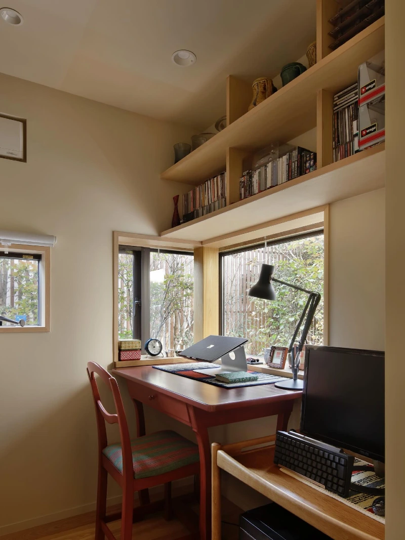 Corner Window Desk with Overhead Library Shelves and Warm Wood Finishes