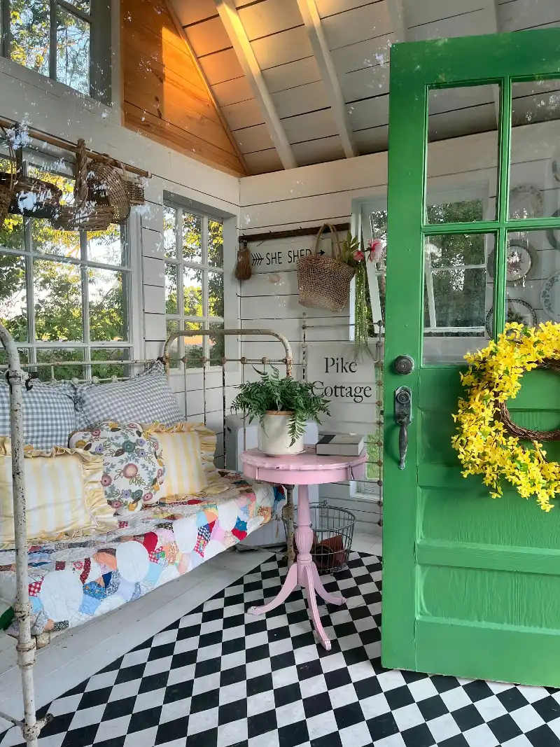 Cottage Daybed Nook with Checkered Flooring and Bright Green Door