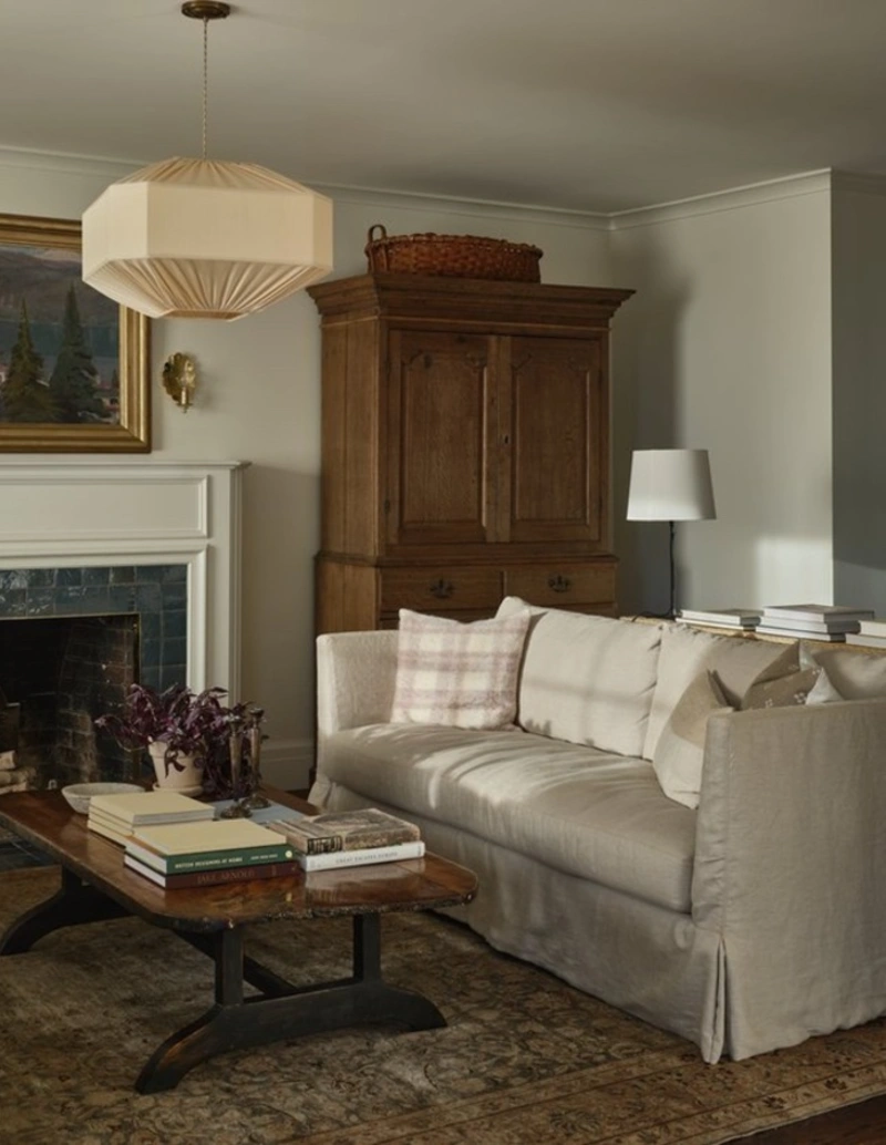 Cream Linen Slipcovered Sofa with Vintage Armoire and Fabric Pendant Lamp