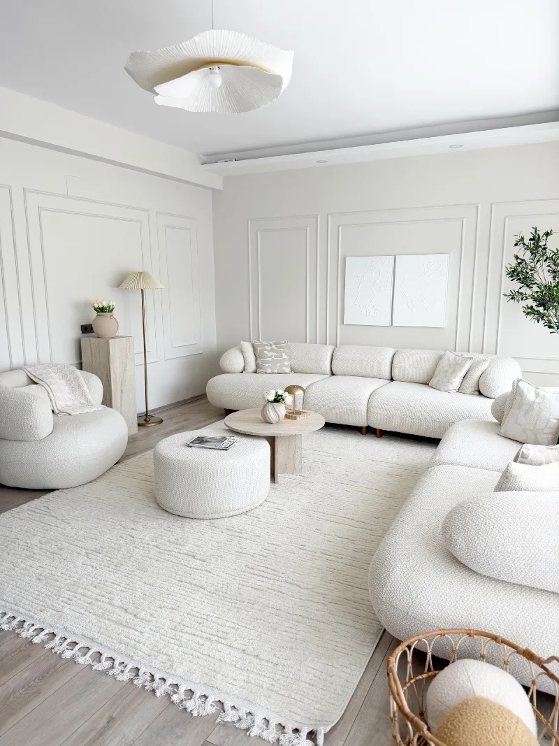 Curved Bouclé Seating with Fluted Wall Panels and Sculptural Ceiling Light
