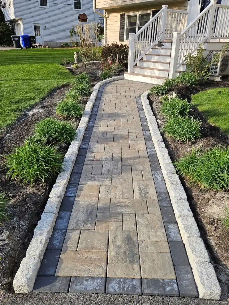 Curved Paver Walkway with Stone Edging and Soft Garden Plantings