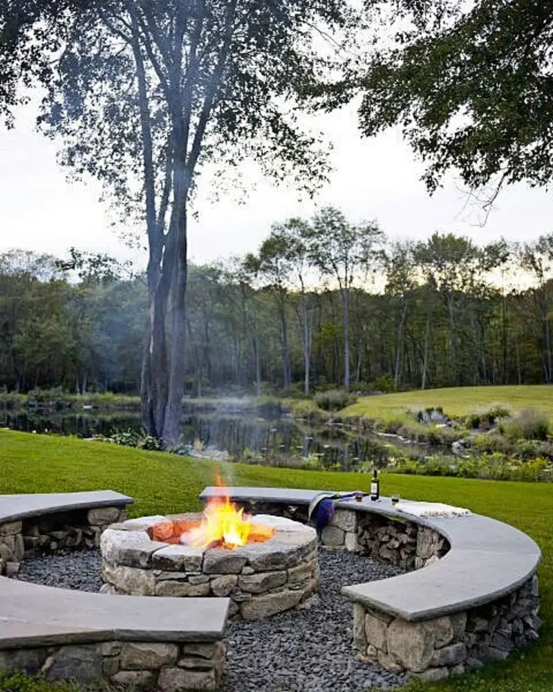 Curved Stone Bench Overlooking a Pond with Central Fire Pit