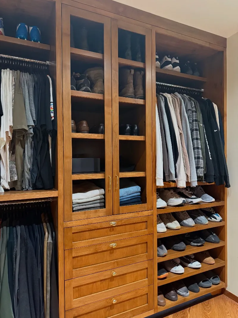 Custom Wood Shelving with Glass Cabinetry and Tiered Shoe Racking