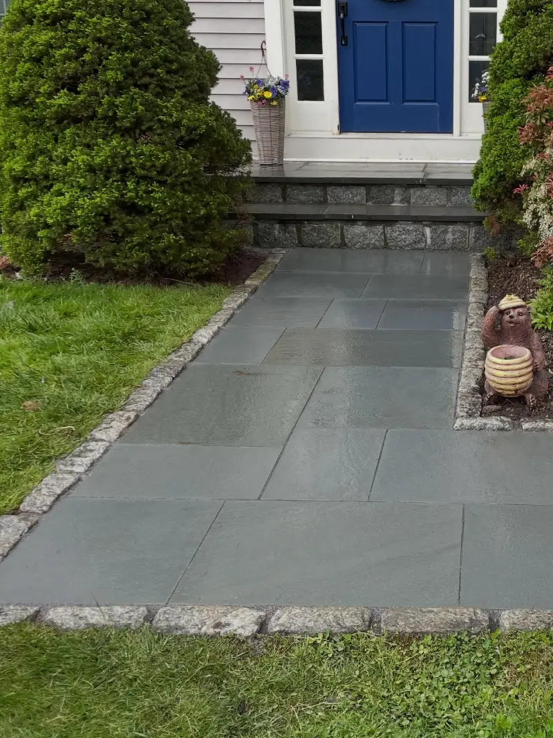  Dark Slate Tile Walkway with Stone Edging and Blue Door Accent