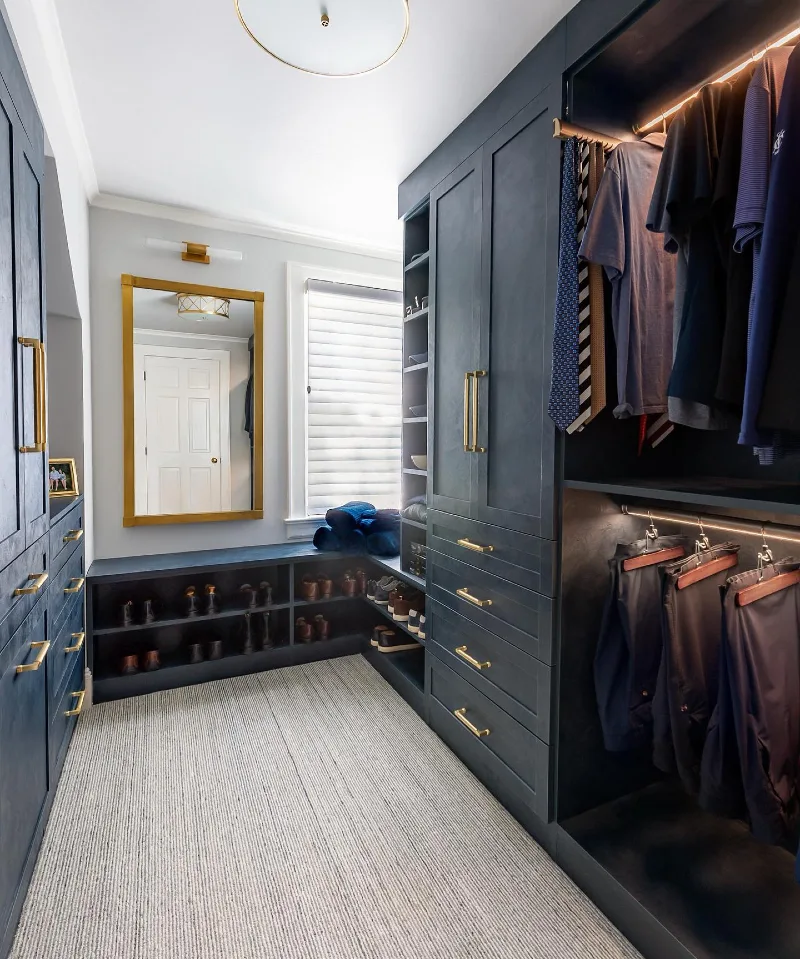 Deep Navy Cabinetry with Brass Accents and Window-Side Bench