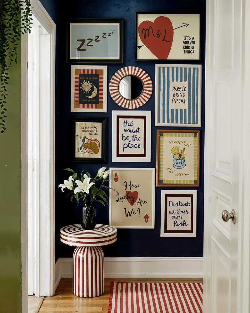 Deep Navy Entryway Nook with Red Striped Pedestal Table, Graphic Text Art, and Matching Accordion Rug