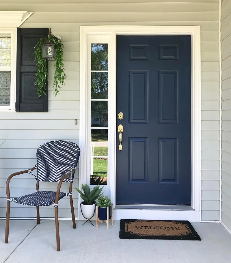Deep Navy Front Door with Brass Hardware and Crisp White Trim