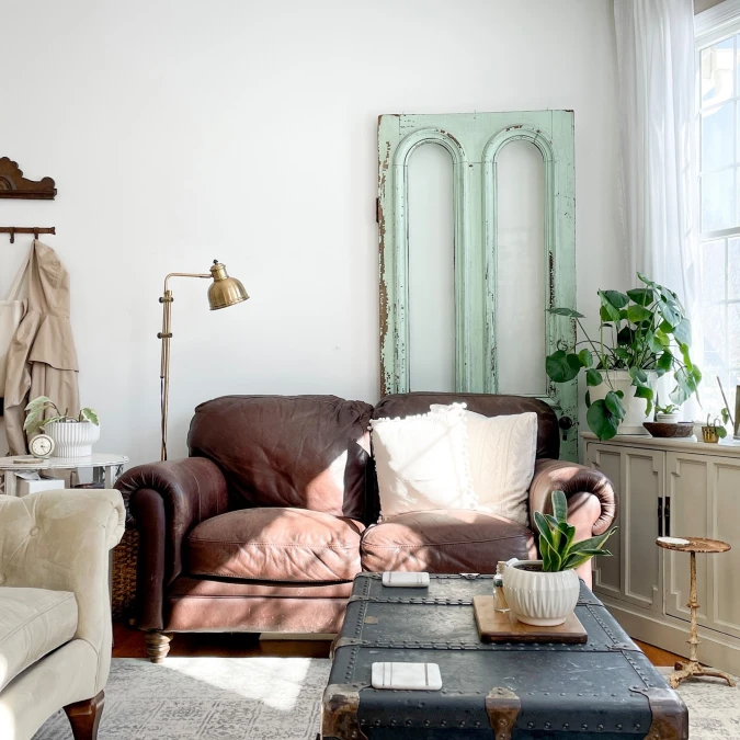 Distressed Architectural Salvage Door Behind Leather Seating