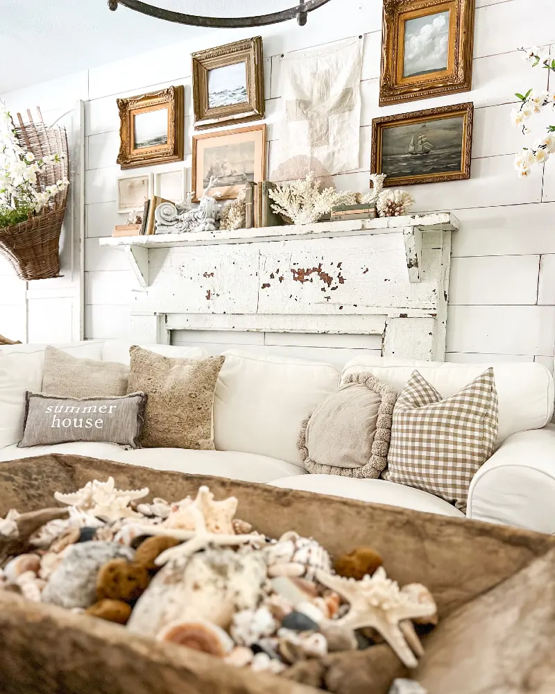 Distressed Mantel with Gilded Seascape Frames and White Shiplap