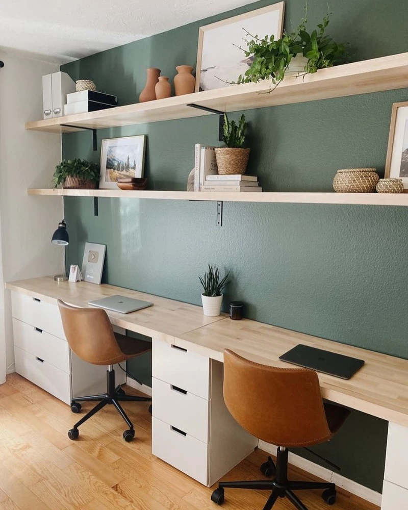 Double Floating Desk with Sage Green Accent Wall and Open Wood Shelves