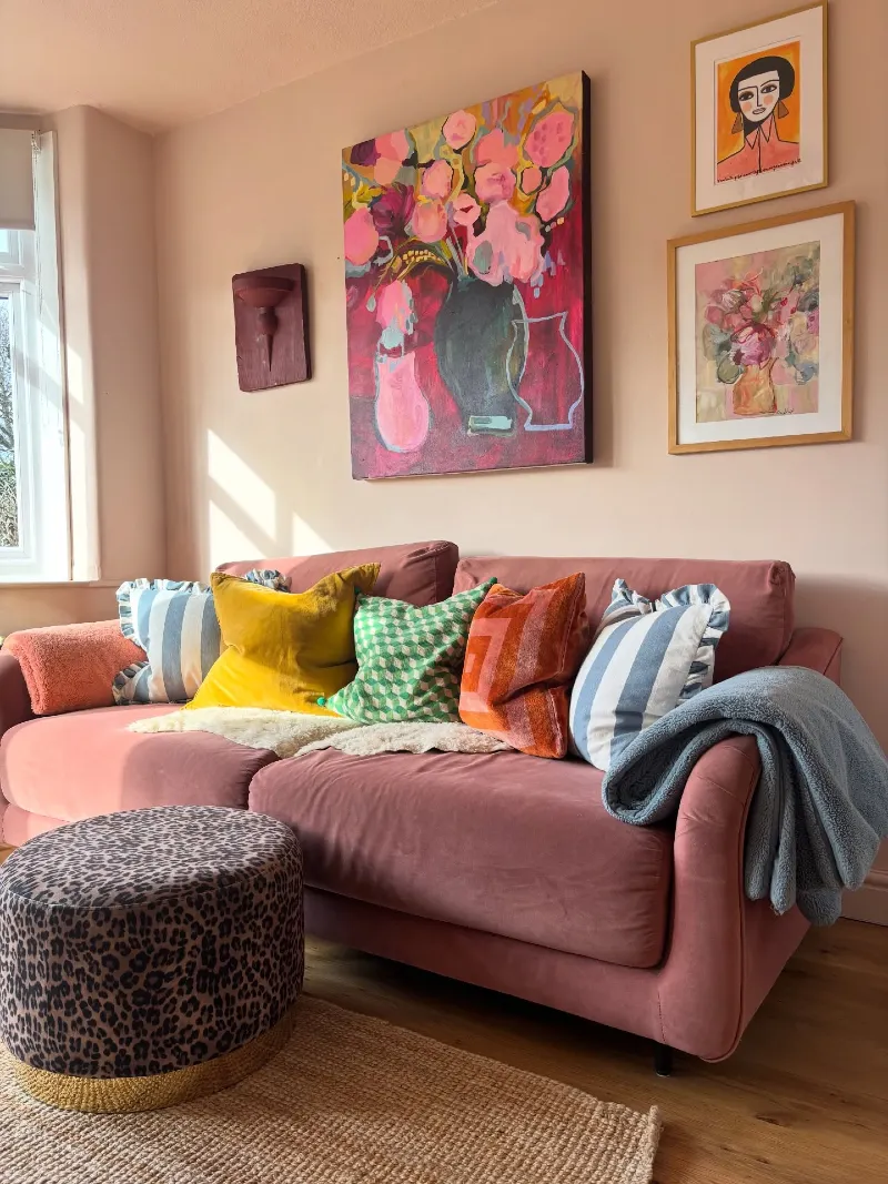 Dusty Rose Velvet Sofa with Leopard Print Pouf and Vibrant Pink Floral Canvas