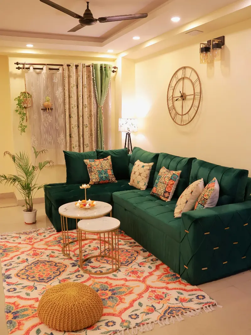 Emerald Green Velvet Sectional with Nesting Marble Tables and Vibrant Patterned Rug