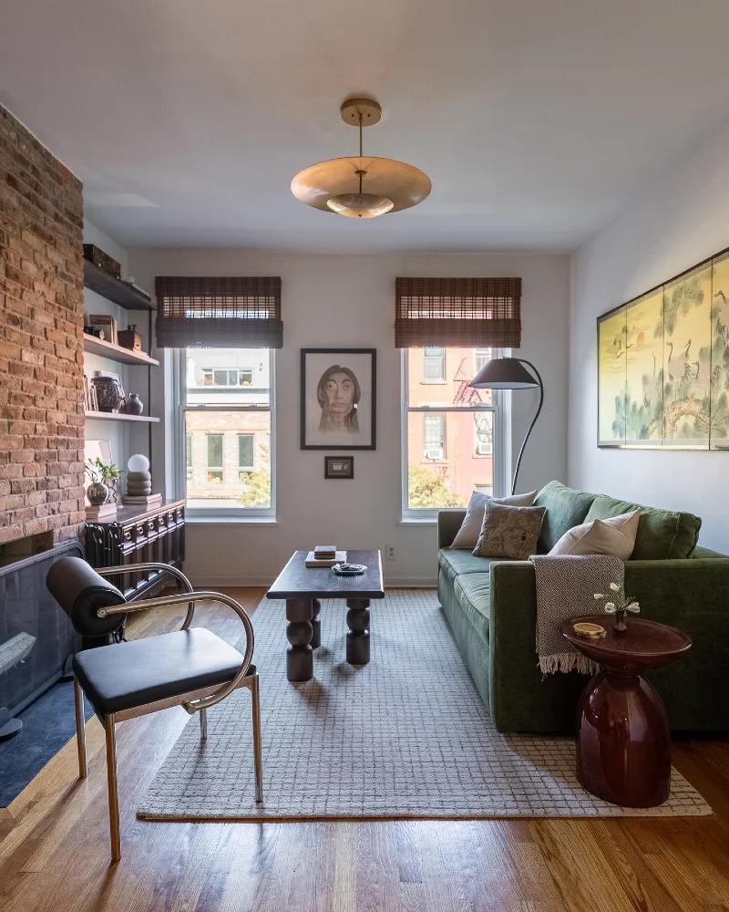 Exposed Brick Fireplace with a Deep Green Velvet Sofa and Gallery Scale Art