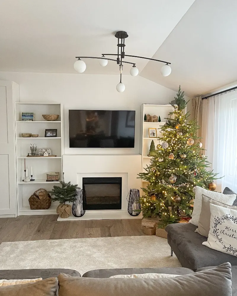 Fireplace Wall with Built-in Shelving and Lit Christmas Tree