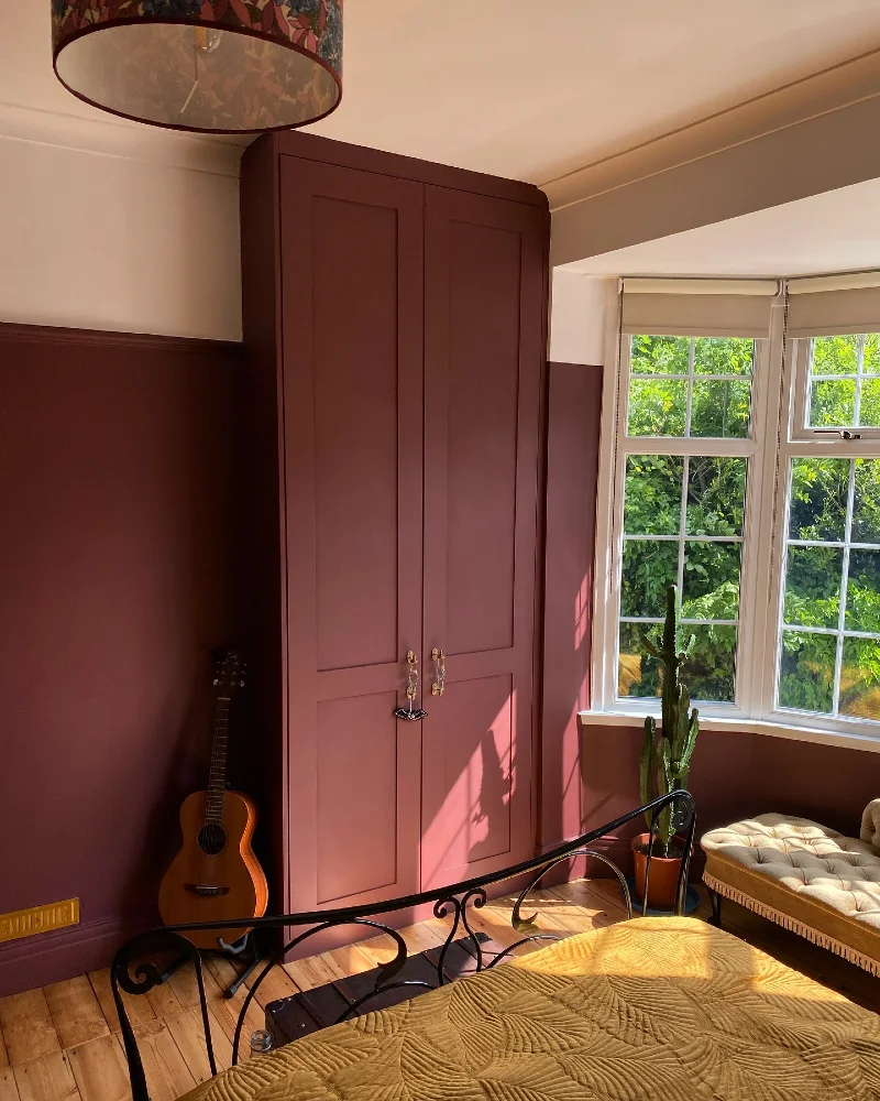 Floor-to-Ceiling Burgundy Wardrobe with Color-Drenched Walls