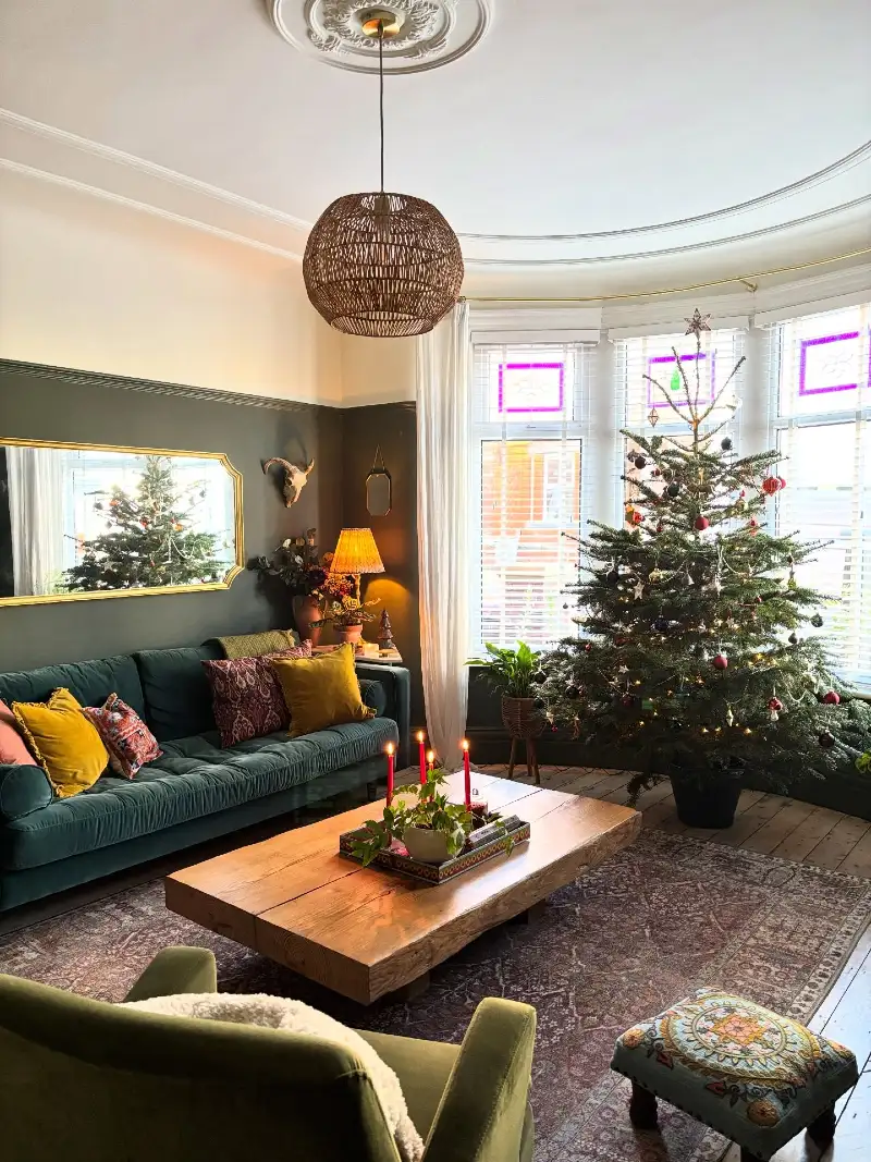 Forest Green Velvet Sofa with Low Wood Coffee Table and Bright Taper Candles