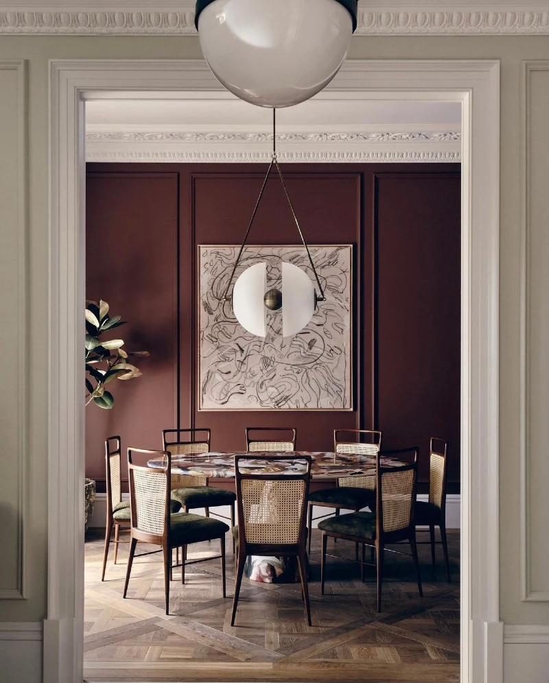 Framed Burgundy Accent Wall with Rattan Dining Chairs