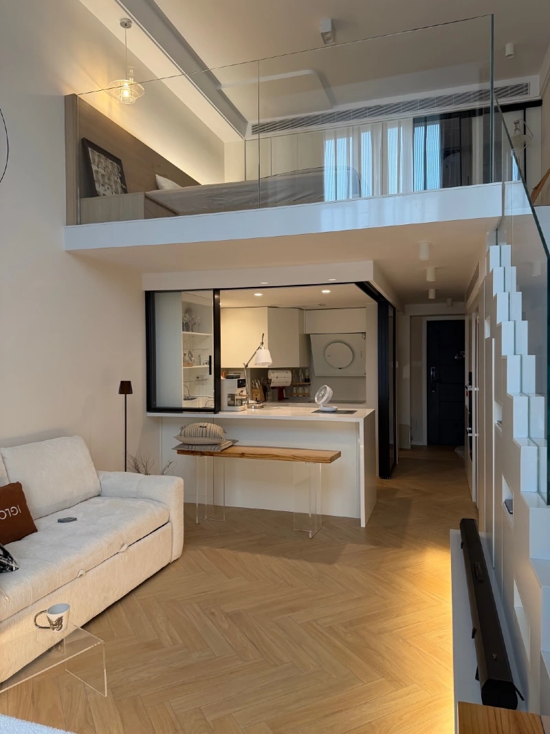 Frameless Glass Mezzanine with Herringbone Wood Floors and Integrated Step Lighting