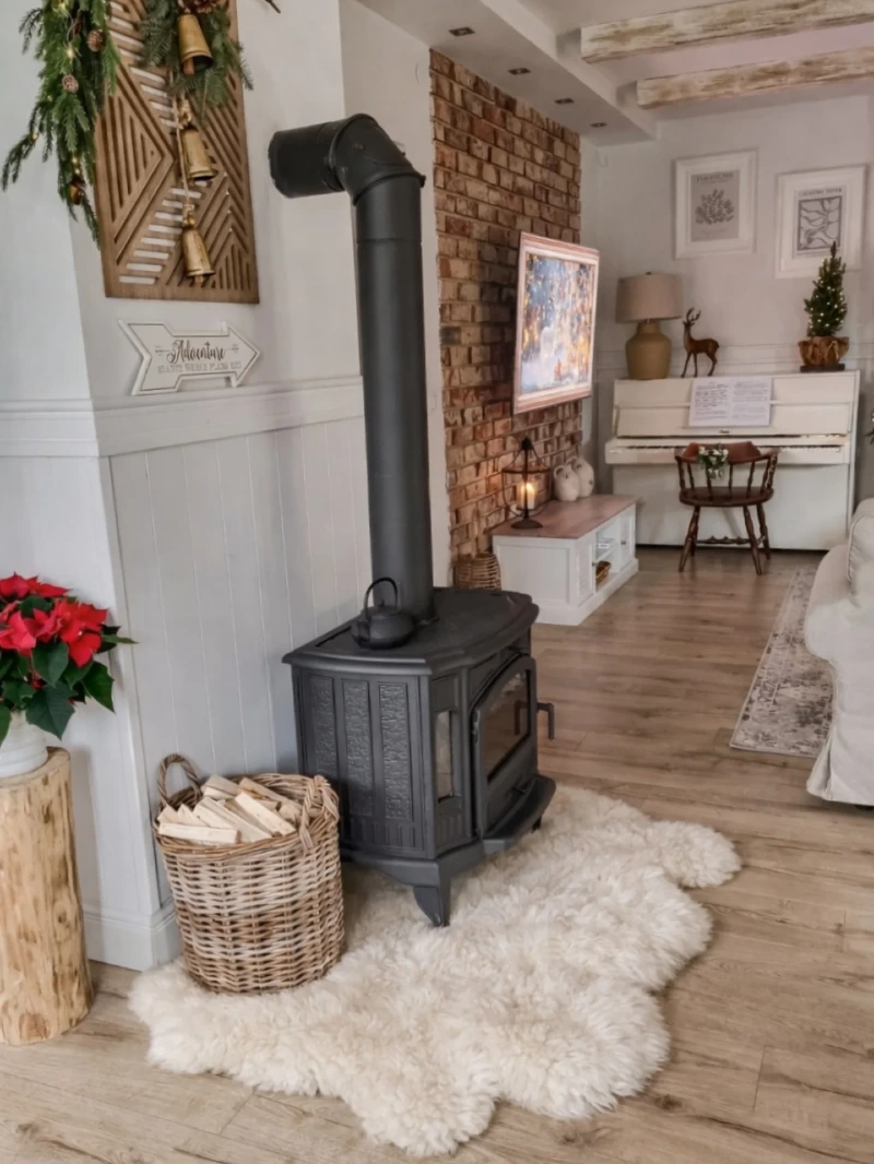 Freestanding Black Wood Stove with Shaggy White Sheepskin and Basket of Logs