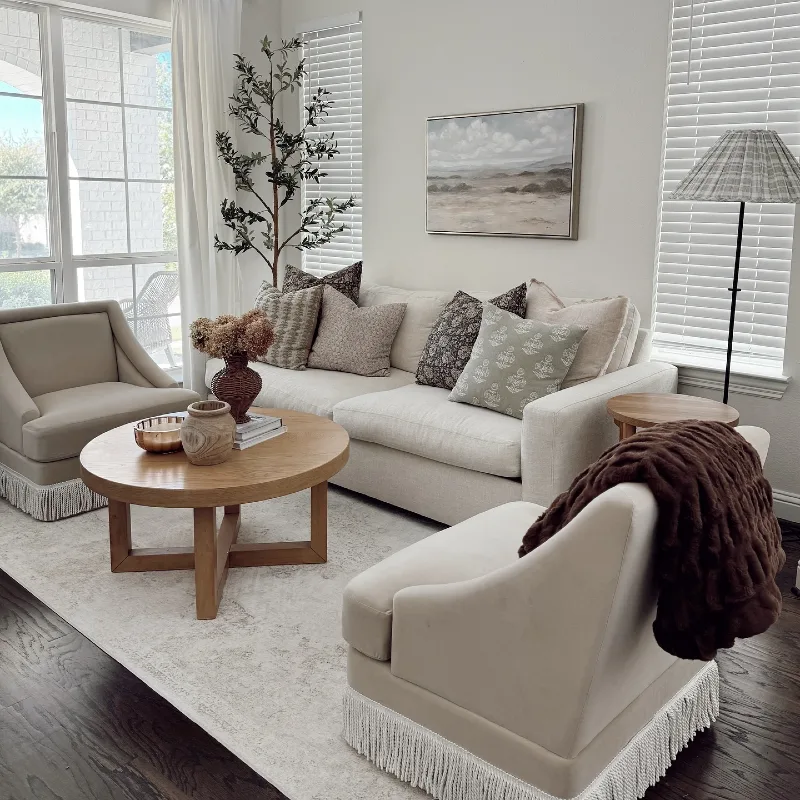 Fringed Armchairs with Cross-Legged Wooden Coffee Table and Landscape Art