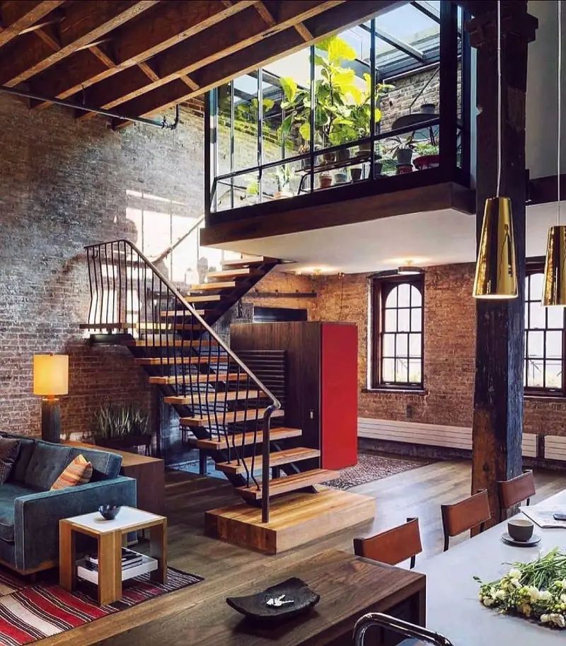 Glass-Enclosed Mezzanine Greenhouse with Floating Timber Stairs and Exposed Brick