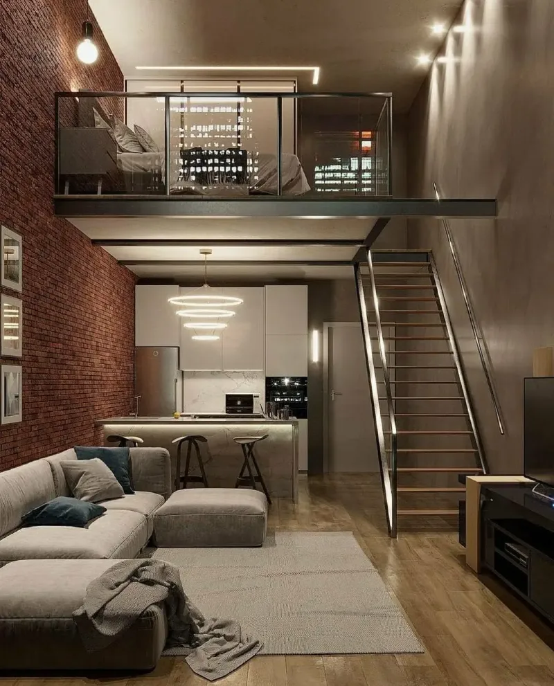 Glass mezzanine bedroom over modern kitchen with exposed red brick wall
