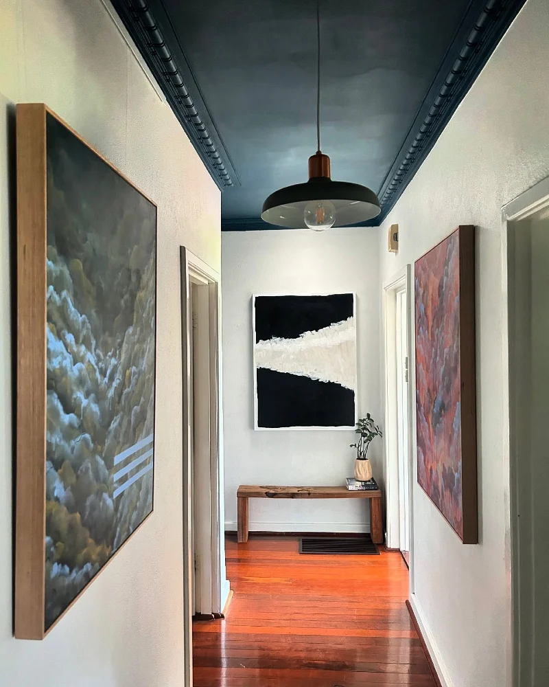 Glossy Teal Ceiling with Ornate Dentil Trim and Mid-Century Black Pendant Lamp