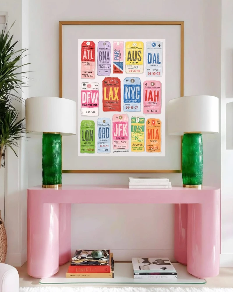 Gold-Framed Airport Baggage Tag Pop Art Above Glossy Pink Console with Green Glass Lamps