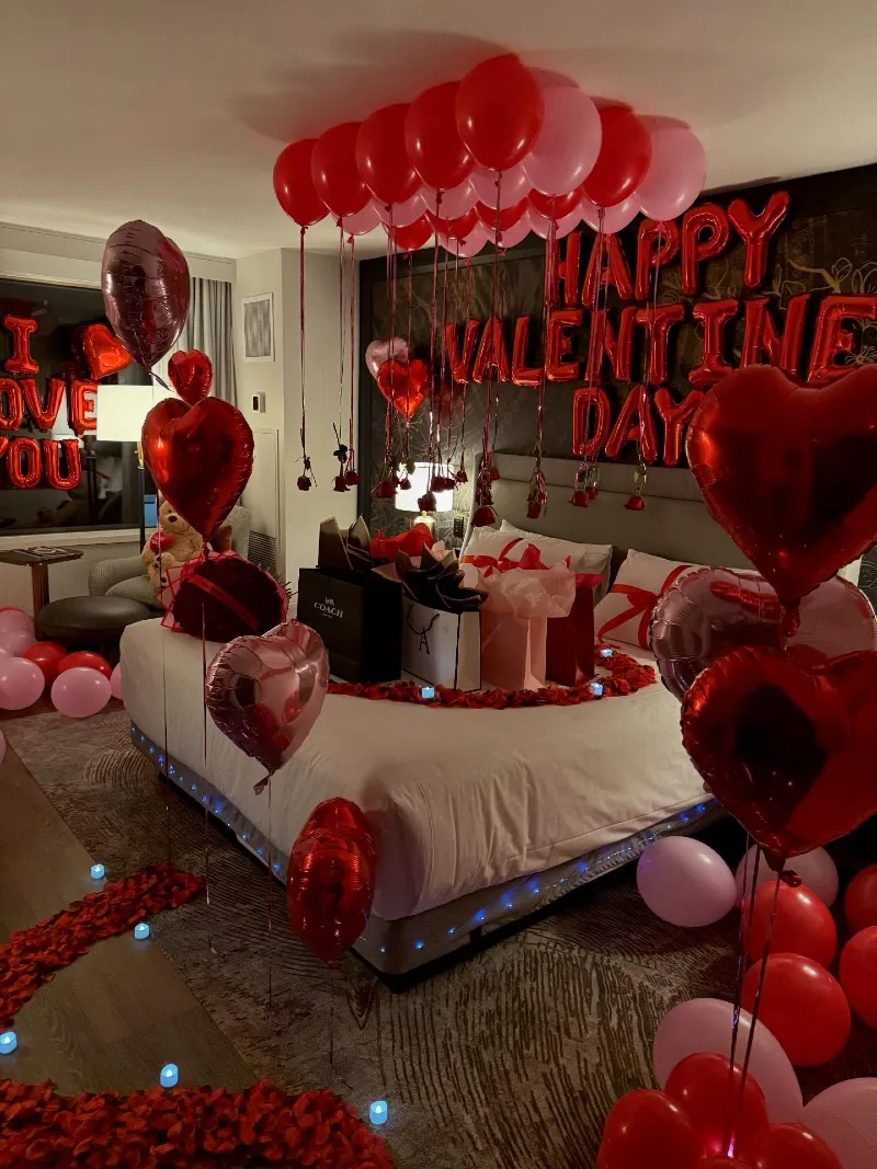 Gray Upholstered Bed with Pink and Red Ceiling Balloons and Hanging Rose Buds