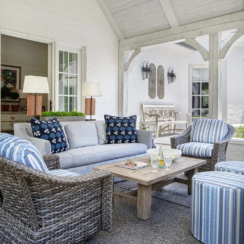 Gray Woven Armchairs with Blue Striped Ottomans and Weathered Wood Coffee Table