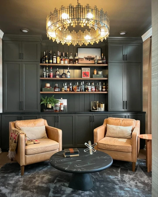 Green Chandelier Bar Wall with Camel Leather Chairs