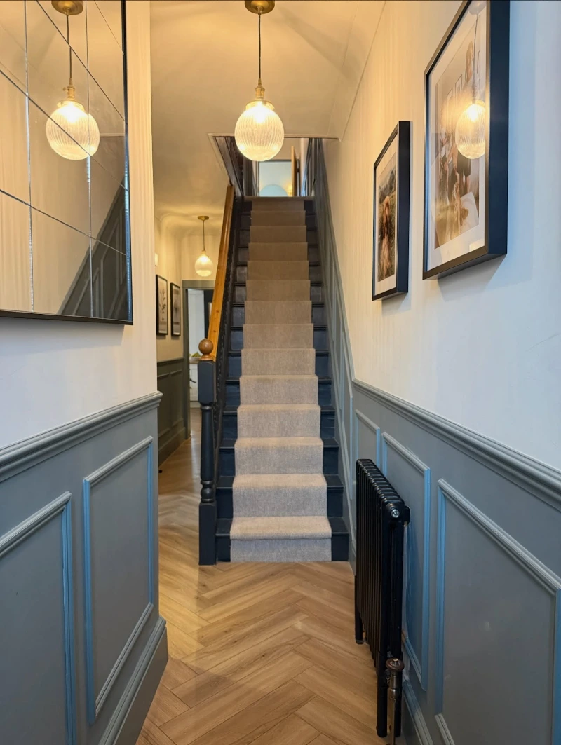 Grid Window Mirror with Slate Blue Wainscoting and Neutral Stair Runner
