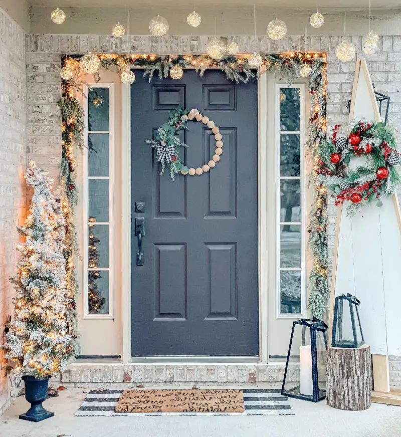 Hanging Glass Globe Lights with a Beaded Wooden Wreath and Layered Doormats