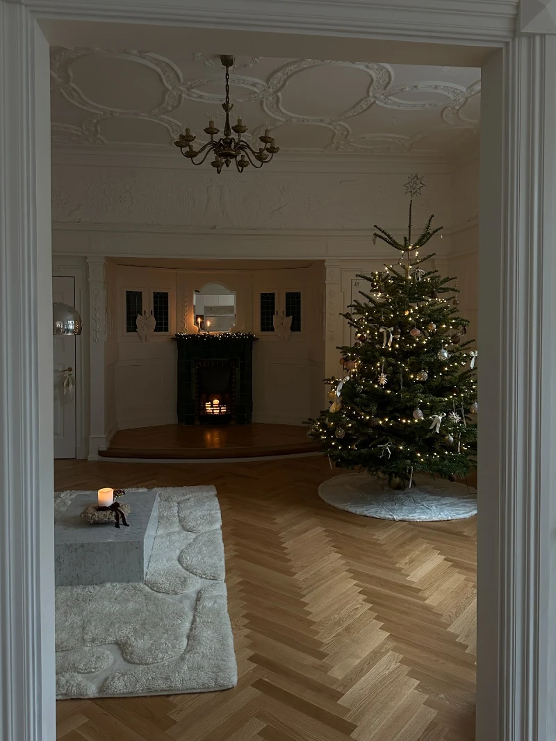 Herringbone Floor with Marble Coffee Table and Lit Christmas Tree