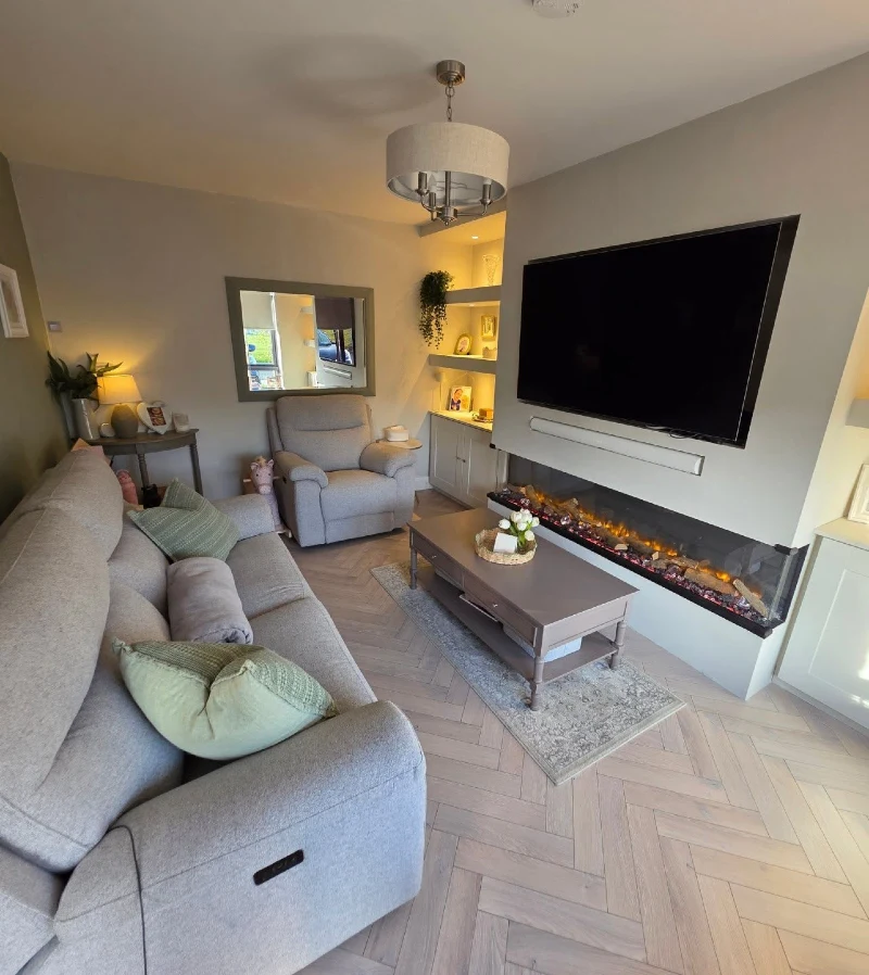 High-Back Reclining Sofa alongside Low Electric Fireplace and Warm Shelf Lighting