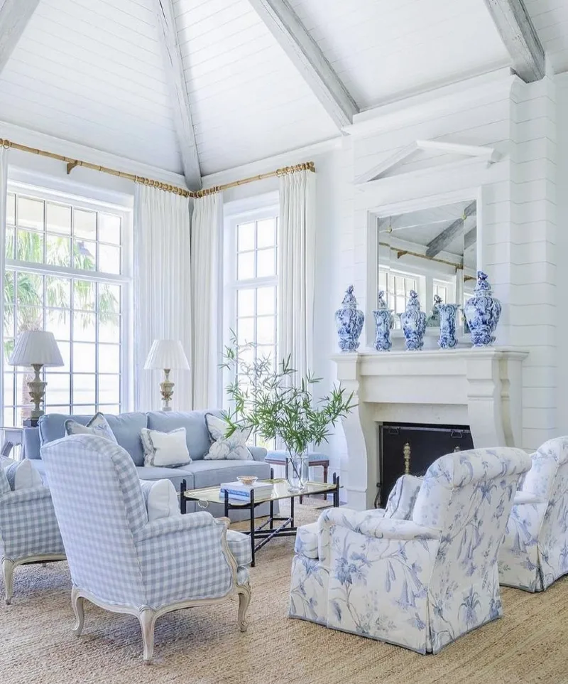High Vaulted Ceiling with Gingham and Chintz Seating Clusters Around a Classic Fireplace
