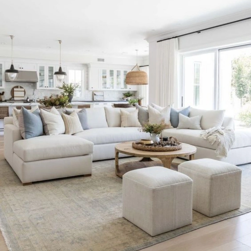 Large Cream Sectional with Soft Blue Pillows and Woven Coffee Table Tray