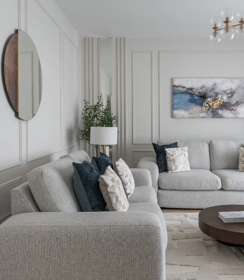 Light Grey Sectionals with Circular Dark Wood Coffee Table and Modern Globe Chandelier