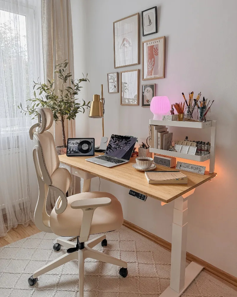 Light Wood Standing Desk with Soft Gallery Wall and Warm Accent Lighting