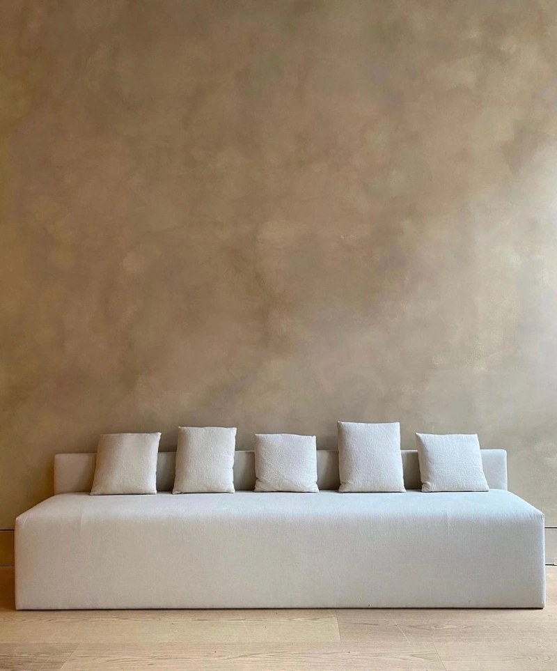 Low-Profile Sofa Against a Richly Toned Plaster Backdrop