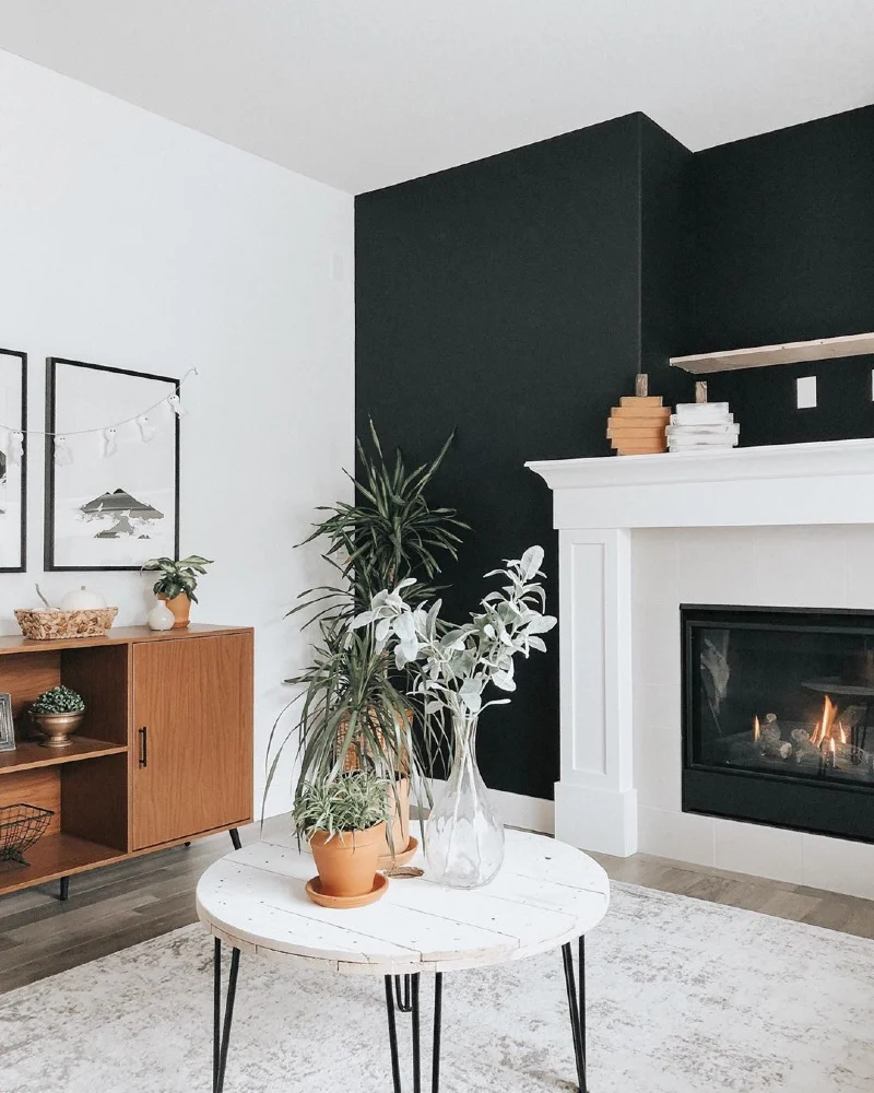 Matte Black Fireplace Alcove with Classic White Mantel and Wooden Credenza