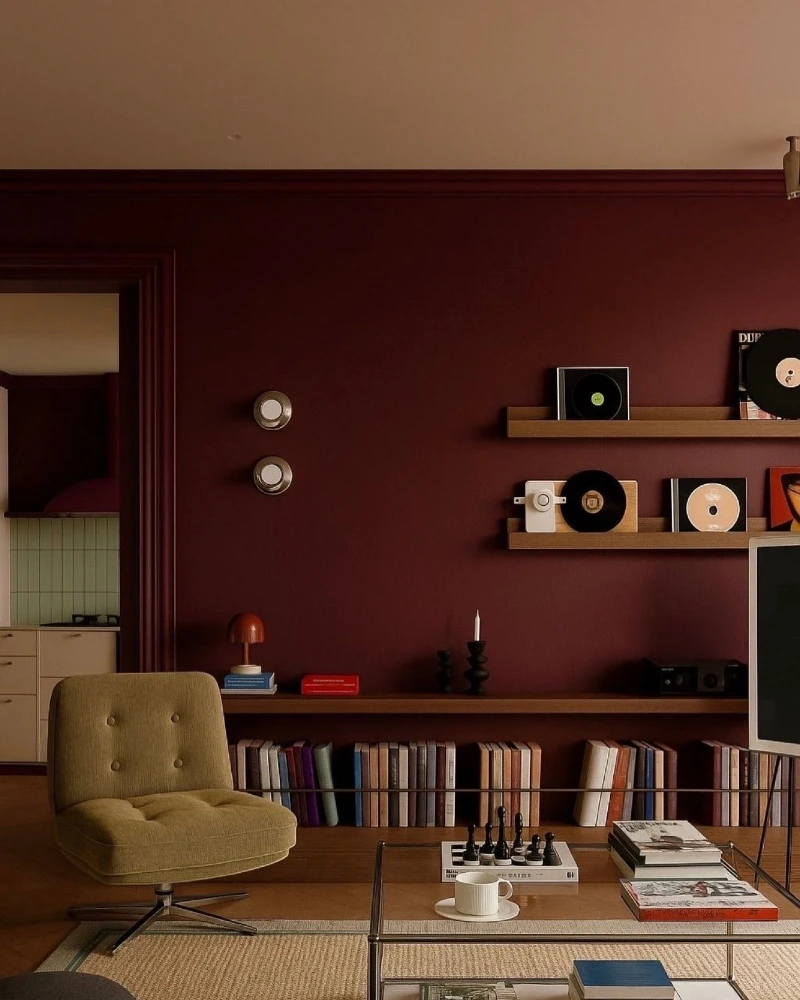 Matte Burgundy Accent Wall with Walnut Floating Shelves