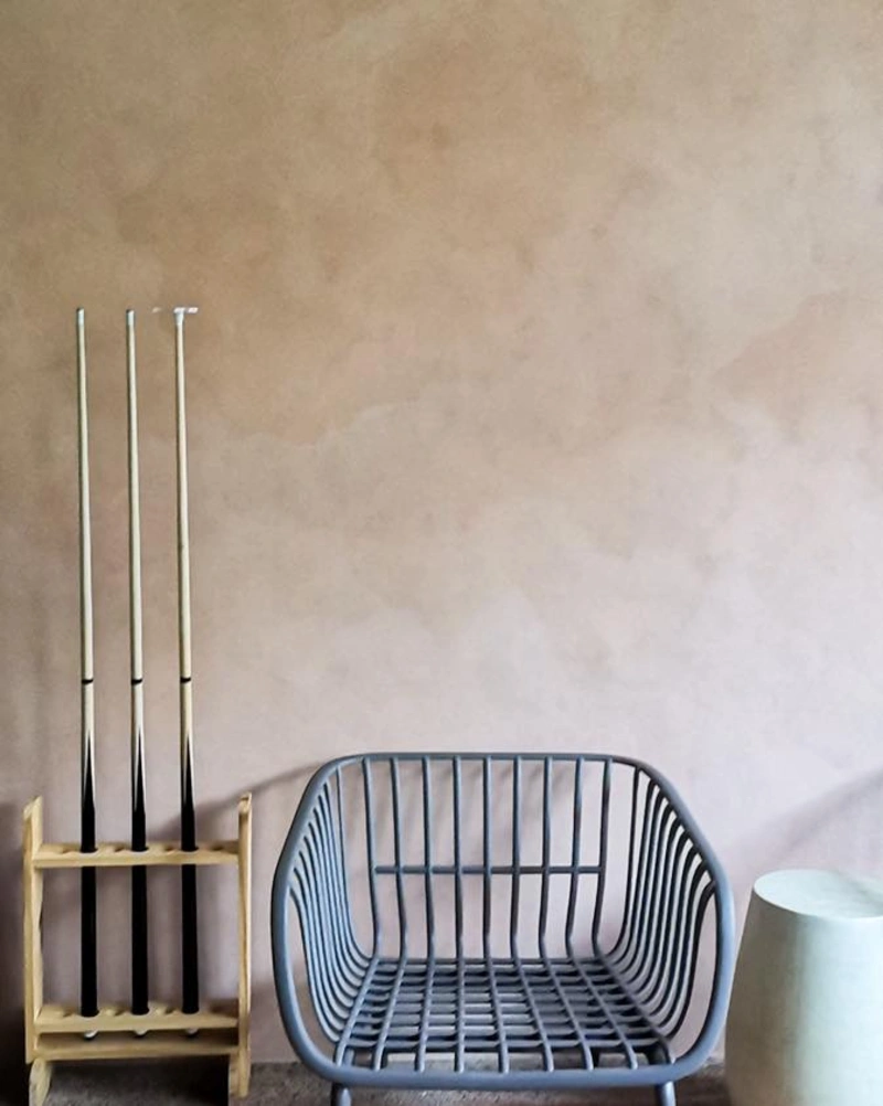 Matte Earth-Toned Wall with Sculptural Gray Seating