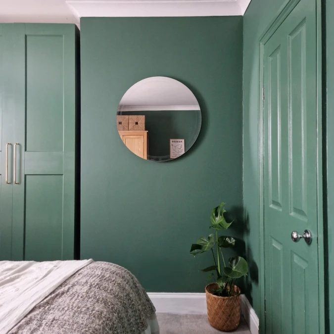Matte Green Bedroom With Round Mirror